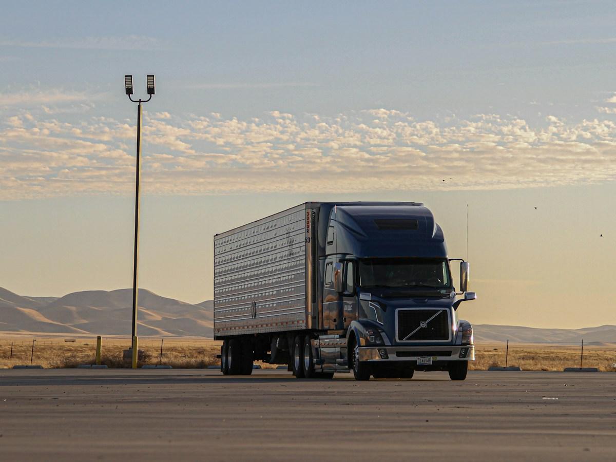 Moving truck parked on an open highway at sunrise